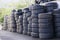 Car tyres stacked recycling compound environment old used rubber black