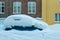 Car under snow. Baklandet street in Trondheim