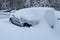 Car under the snow. Heavy snow.