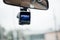 Car video recorder car dash camera.  Video recorder under view mirror in car .Soft focus