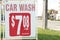 car wash 708 7 dollars plus tax minimum 25 litre gas sign advertisement. ph