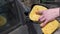 Car wash. Close-up of female hands. A woman washes the Car rearview mirror