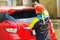 Car wash service., Self-cleaning car wash., The young man was washing the car to be clean and safe from germs.