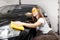 Car wash service, worker beautiful girl polishes and clean microfiber headlights on black auto