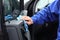 Car wash worker cleaning automobile interior