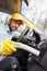 Car wash worker cleaning inside of car with vacuum cleaner