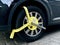 Car wheel blocked by wheel lock because illegal parking violation Wheel lock for anti-theft with the car on the road or concrete