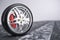 Car wheel, car tire standing on a road. Concept winter tyres. Winter tires with snowy background. Car tire with a disc