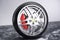 Car wheel, car tire standing on a road. Concept winter tyres. Winter tires with snowy background. Car tire with a disc