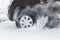 Car wheel close-up rides and skidding on a snowy winter road