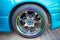 Car wheel on colorful metallic disc, close up photo