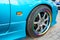 Car wheel on colorful metallic disc, closeup photo