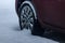 Car wheel covered in fresh white snow