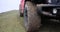 Car wheel with dirty wheels standing on rural road