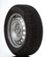 Car wheel and winter studded tire on white