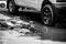 car wheels on mud-stained asphalt