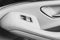 Car white leather interior details of door handle with windows controls and adjustments. Car window controls of modern car. Car de
