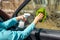 Car windows cleaning. female hands cleaning car window with green microfiber cloth and spray bottle with blank white label