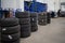 In car workshop there are many stacked car tires