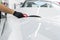 Car wrapping specialist putting vinyl foil or film on car. Protective film on the car. Applying a protective film to the car with