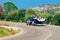 Car with yacht or motor boat in road in Sardinia