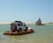 Cara crossing the river in primitive boat in Camocim, Ceara, Brazil