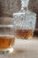 Carafe and glass of whisky, whiskey bourbon on a burlap, sacks background