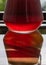 Carafe of red wine on a reflective surface - outdoor table