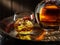 Carafe of whisky and glass of whisky on old wooden cask at the dark background