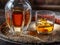 Carafe of whisky and glass of whisky on old wooden cask at the dark background