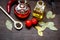 Carafes with oil and tomatoes on wooden background