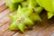 Carambola fruit on wooden table closeup