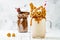 Caramel and chocolate crazy freakshake, milkshakes with brezel waffles, popcorn, marshmallow, ice cream and whipped cream.