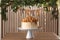 Caramel drip cake decorated with popcorn and pretzels on wooden table