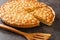 Caramel macadamia tart baked in a buttery homemade shortcrust pastry closeup in the board. Horizontal