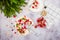 Caramel Pavlova Christmas wreath with cherry sauce, pomegranate, cranberries and kiwi on a light stone background.
