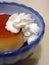 Caramel pudding with whipped cream