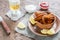 Caramelized chicken wings with glass of beer