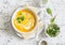 Caramelized golden beet and fall roots soup on a light background, top view. Vegetarian food