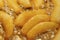 Caramelized sliced pears in honey syrup in a pan, closeup. Delicious dessert for holiday