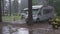 Caravan in campground during heavy rain. Vasted vacation bad weather concept.