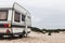 Caravan Camping Trailer On The Beach. Resting Tourism Vacation Concept
