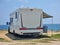 caravan car by the beach in summer holidays modern