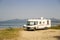 Caravan car modern by the sea in spring season in greece