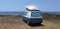Caravan car solar panels electricity  by the sea in summer beach trees blue sky  travel