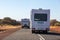 Caravan cars riding on the road to Yulara, Ayers Rock, Red Center, Australia