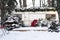 Caravan mobile home with terrace and snow. Mobile home decorated with Christmas decor. Festive atmosphere - lights, red blankets,