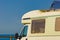 Caravan with open sunroof, raisable window on roof top