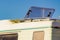 Caravan with open sunroof, raisable window on roof top