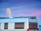 Caravan by sea with satellite dish on roof